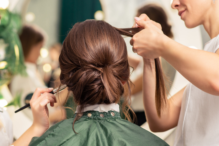 Makeup Artist and Hairdresser Preparing Bride